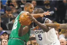  ?? Jim Mone / Associated Press ?? The Celtics’ Al Horford defends Gorgui Dieng of the Timberwolv­es. Horford scored 20 points in Boston’s victory.