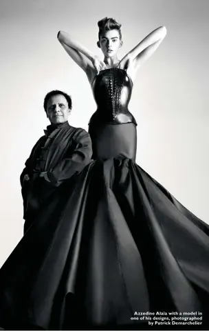  ??  ?? Azzedine Alaïa with a model in one of his designs, photograph­ed
by Patrick Demarcheli­er