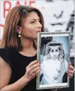  ?? CHRISTIAN LUTZ AP FILE PHOTO ?? Ensaf Haidar with a photo of jailed husband, blogger Raif Badawi.