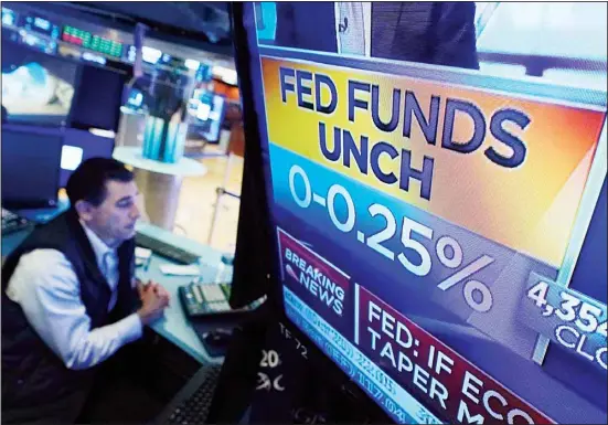  ?? ?? A screen on the floor of the New York Stock Exchange shows the rate decision of the Federal Reserve, on Sept. 22, 2021. The yield on the 10-year Treasury is still below where it was in the spring. (AP)