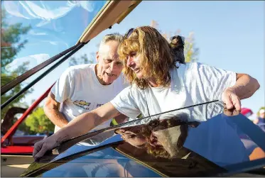  ?? NWA Democrat-Gazette/CHARLIE KAIJO ?? Wally, the marmoset monkey, rests Saturday on the shoulder of Sheryl Millard as she and Tom Millard of Rogers detail their ’86 Chevrolet Camaro Z-28 at the Arvest Ballpark in Springdale. The Arvest Ballpark hosted the Bikes, Blues & BBQ car show. For...