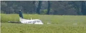  ?? NIKKI BOERTMAN/AP ?? A Beechcraft King Air rests in a soybean field after the pilot crash-landed Saturday near Ripley, Miss.