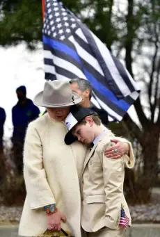  ?? ?? Susan Gilmore and her son, Gil, hug one another during a Line of Duty Death Commemorat­ion ceremony for Boulder Officer Eric Talley outside of the Boulder Police Department on Tuesday.