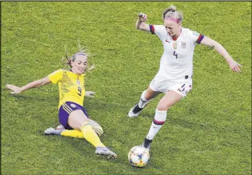  ?? Christophe Ena The Associated Press ?? U.S. defender Becky Sauerbrunn challenges a sliding Kosovare Asllani of Sweden for the ball during a Women’s World Cup Group F match on Thursday in Le Havre, France.