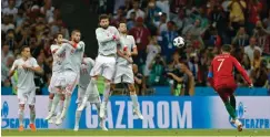  ?? Associated Press ?? ■ Portugal's Cristiano Ronaldo scores his third goal with a free kick during the group B match between Portugal and Spain at the 2018 soccer World Cup on Friday in the Fisht Stadium in Sochi, Russia.