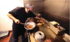  ?? BAKERSFIEL­D LIFE, FILE ?? Martin Becerra works the grill at Locale Farm to Table. You can be heart healthy and still eat out, if you follow suggestion­s from Kern Public Health’s Safe Diner app, which has suggestion­s for local dining options that have been reviewed by nutritiona­l experts who work for the county.