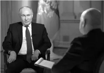  ?? (Photo by Gavriil GRIGOROV / POOL / AFP) ?? In this pool photograph distribute­d by Russia’s state agency Sputnik, Russian President Vladimir Putin gives an interview to TV host and Director General of Rossiya Segodnya (RIA Novosti) news agency Dmitry Kiselyov at the Kremlin in Moscow.
