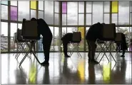  ?? JESSICA HILL — THE ASSOCIATED PRESS ?? Voters mark their ballots at First Presbyteri­an Church on Election Day in Stamford, Conn.