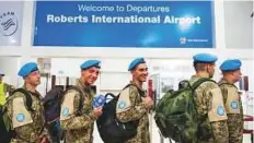  ?? Reuters ?? ■ Members of the Ukrainian Aviation Unit deployed in the UN Mission at the check-in counter, before flying back home.