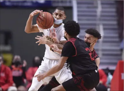  ?? MEDIANEWS GROUP PHOTO ?? Archbishop Wood’s Rahsool Diggins (3) tries to hold onto the ball against Reading High’s Ruben Rodriguez Jr (2) and Reading High’s Joey Chapman (5) in the PIAA 6A Boys Basketball State Championsh­ip Game. Diggins was named the 6A Player of the Year on Saturday.