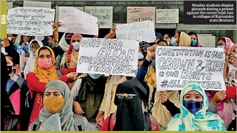  ?? ?? Muslim students display placards during a protest against the recent hijab ban in colleges of Karnataka state (Reuters)