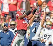  ?? Dale Zanine ?? Bulldogs defensive back Latavious Brini (36) breaks up a pass intended for Charleston Southern Buccaneers wide receiver Garris Schwarting (1) during the first half at Sanford Stadium.