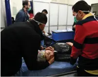  ?? (Reuters) ?? A WOMAN lies on a stretcher inside a hospital in Aleppo on Saturday after the suspected gas attack.