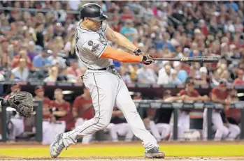  ?? CHRISTIAN PETERSEN/GETTY IMAGES ?? Giancarlo Stanton singles during the third inning Sunday in Phoenix against the Diamondbac­ks.