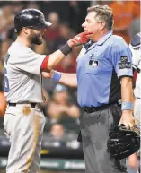  ?? Eric Christian Smith / Associated Press ?? Boston’s Dustin Pedroia makes a point with umpire Greg Gibson after Houston’s James Hoyt plunked Pedroia on Sunday.
