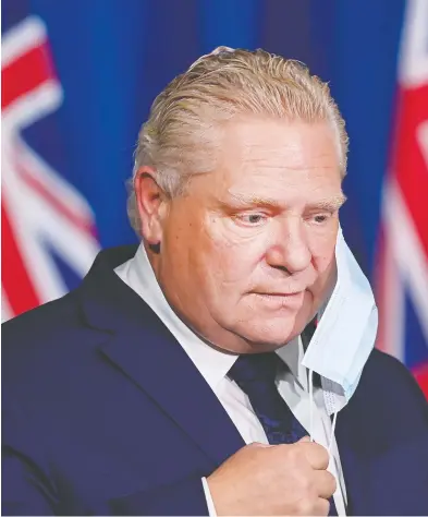  ?? NATHAN DENETTE / THE CANADIAN PRESS ?? Ontario Premier Doug Ford arrives at a press conference at the legislatur­e at Queen's Park during the COVID-19 pandemic in Toronto on Tuesday. The provincial government unveiled a new tiered system for COVID-19 restrictio­ns.