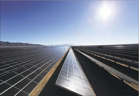  ?? Marcus Yam / TNS ?? The morning sun rises over the photo-voltaic solar panels at the 550-megawatt Desert Sunlight Solar Farm in Desert Center, Calif., on Feb. 9, 2015. The photo-voltaic solar farm is one of the world’s largest, covering 3,800 acres of federal land in Riverside County.