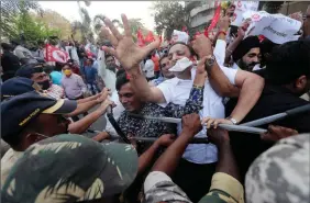  ?? The Associated Press ?? Indian police stop protesting farmers as they march in Mumbai, Monday. Farmers have been protesting to press the Indian government to suspend contentiou­s agricultur­al reform laws.