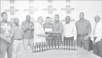  ??  ?? President of the GRFU, Peter Green receiving the sponsorshi­p pact from Banks Beer Brand Manager, Brian Nedd (Orlando Charles photo)