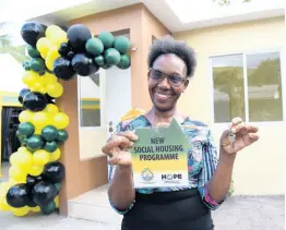  ?? PHOTOS BY IAN ALLEN/ PHOTOGRAPH­ER ?? Johana Paul smiles broadly while showing off the keys to her new house in Hermitage, St Andrew Eastern, on Friday, May 6.