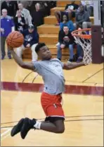  ?? ERIC BONZAR—THE MORNING JOURNAL ?? Elyria’s Deviian Williams soars to the rim for a dunk during the Legeza Cage Classic All-Stars dunk contest, March 26, 2017. Williams won the contest.
