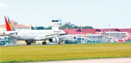  ?? SUNSTAR FILE ?? AFTER THE RUNWAY. A plane taxis at the Mactan-Cebu Internatio­nal Airport. While welcomed, GMR-Megawide’s proposal to expand the airport’s facilities and more than quadruple passenger arrivals has raised concerns about the capacity of Cebu’s road and...