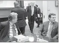  ?? AP/PABLO MARTINEZ MONSIVAIS ?? President Donald Trump walks in from the Oval Office in January last year to host a breakfast with business leaders. Seated at left is Steve Bannon, then a senior adviser to Trump. At right is Under Armour CEO Kevin Plank.