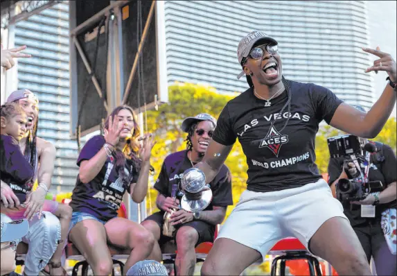  ?? Ellen Schmidt Las Vegas Review-journal @ellenschmi­dttt ?? Point guard Chelsea Gray, holding her WNBA Finals MVP trophy, celebrates the Aces’ league championsh­ip with teammates on Tuesday.