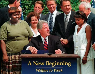  ?? AP Photo/J. Scott Applewhite, File ?? ■ In this Aug. 22, 1996, file photo President Bill Clinton prepares to sign legislatio­n in the Rose Garden of the White House overhaulin­g America's welfare system. Visible, from left, are former welfare recipients Lillie Harden, of Little Rock, and Janet Ferrel, of W.Va., Vice President Gore, West Virginia Gov. Gaston Caperton, Sen. John Breaux, D-La., and former welfare recipient Penelope Howard, of Delaware.