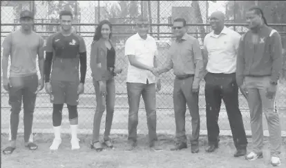  ??  ?? Secretary of the Guyana Cricket Board (fourth from left) shaking hands with President of Everest Cricket Club, Manzoor Nadir (blue shirt) in the presence of, from left, Gudakesh Motie, Akshaya Persaud, Rehana Ragoobeer, Colin Stuart and Clinton Pestano