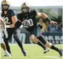  ?? EBENHACK/AP PHELAN M. ?? UCF quarterbac­k John Rhys Plumlee (10), right, scrambles for yardage in front of Georgia Tech defensive lineman Sylvain Yondjouen (32) during the first half Saturday.