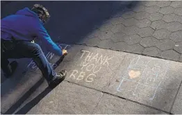  ?? CRAIG RUTTLE AP ?? Kimberly Miller, of the Brooklyn borough of New York, leaves a chalk message honoring Justice Ruth Bader Ginsburg on a Washington Square Park walkway Saturday.