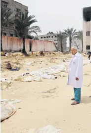  ?? ?? A doctor inspects bodies unearthed from a mass grave in the southern Gaza Strip, Palestine, April 25, 2024.