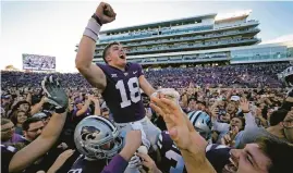  ?? CHARLIE RIEDEL/AP ?? Kansas State QB Will Howard (18) celebrates with the crowd as he is carried off the field by teammates after Saturday’s win over Oklahoma State in Manhattan, Kan.
