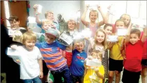  ?? COURTESY PHOTO ?? A group of youngsters enjoy their success in completing a Cookie BOOKie Club program. The readers finished Stone Fox and celebrated with a book worm party.