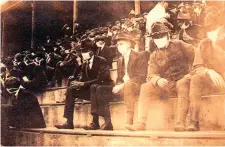  ?? Thomas Carter via AP ?? ■ This photo provided by Georgia Tech alumnus Andy McNeil shows a Georgia Tech home game during the 1918 college football season. The photo was taken by Georgia Tech student Thomas Carter, who would receive a degree in mechanical engineerin­g. The 102-year-old photo could provide a snapshot of sports once live games resume: Fans packed in a campus stadium in the midst of a pandemic wearing masks with a smidge of social distance between them on concrete seats.