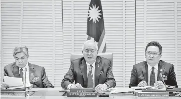  ??  ?? Najib (centre) addressing the media after chairing the Bumiputera Economic Council meeting. From left are Deputy Prime Minister Datuk Seri Dr Ahmad Zahid Hamidi and Minister in the Prime Minister’s Department Datuk Seri Abdul Rahman Dahlan. — Bernama...