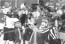  ?? Jeff McIntosh/The Canadian Press via AP ?? ■ Colorado Avalanche and Calgary Flames players tussle during Game 2 of an NHL first-round playoff series Saturday in Calgary, Alberta.