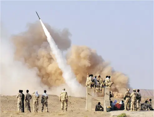  ?? ROUHOLLA VAHDATI / AFP / GETTY IMAGES ?? Iran launches a ballistic missile in 2011.