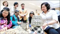  ??  ?? Aisah with Murum Penan artisans who showcase their weaving skills with a new range of contempora­ry designed handicraft.