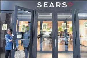  ?? CP PHOTO ?? Shoppers enter and leave a Sears retail store in Toronto on Oct. 19, 2017.