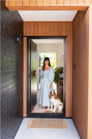  ??  ?? The black painted brick softened with vertical cedar shiplap was a cost-e ective choice. The breeze-block wall looks stylish and give privacy at the front of the home. ENTRANCE