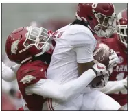  ?? (NWA Democrat-Gazette/Charlie Kaijo) ?? LaDarrius Bishop (left), here tackling Alabama wide receiver John Metchie in last year’s game, showed his skills as a cover talent late in the season and could be among the starters in the backfield.