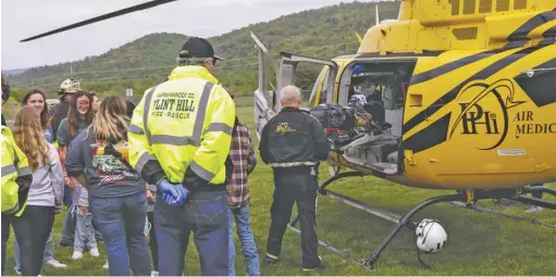  ?? ?? Below: A student actor is loaded onto a medevac helicopter.