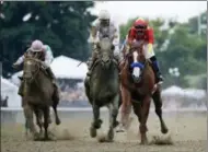  ?? JULIO CORTEZ — THE ASSOCIATED PRESS ?? Justify (1), with jockey Mike Smith up, right, crosses the finish line ahead of Gronkowski, right, with jockey Jose Ortiz up, to win the 150th running of the Belmont Stakes horse race and the Triple Crown, Saturday in Elmont, N.Y.