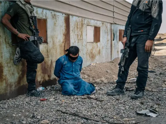  ??  ?? Iraqi forces detain a man suspected of having links to Isis in November (Photos by Alice Martins/Washington Post)