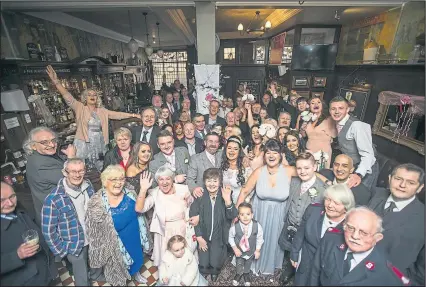  ??  ?? Friends and family join Linda McVean and Jonnie Gunn on their special day at Denholms, the bar where they first met
