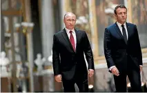  ?? PHOTO: REUTERS ?? Russian President Vladimir Putin and French President Emmanuel Macron arrive for their press conference at the Chateau de Versailles.
