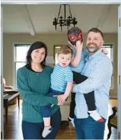  ?? JOHN J. KIM/CHICAGO TRIBUNE ?? Rachel and Kevin Trenkamp hold their sons, Zachary, 2, center left, and Benjamin, 5, at their home in Aurora on March 14.