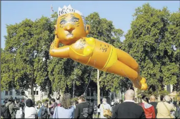  ?? Tim Ireland The Associated Press ?? An inflatable caricature balloon of London Mayor Sadiq Khan is released Saturday over Parliament Square.